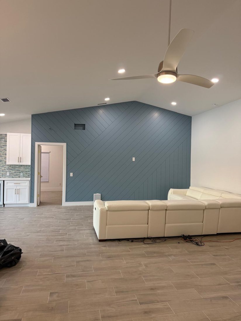 Accent wall in a single deep tone, the same surface after the work was finished