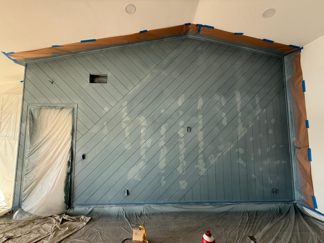 Accent wall in a single deep tone, the surface before the work started