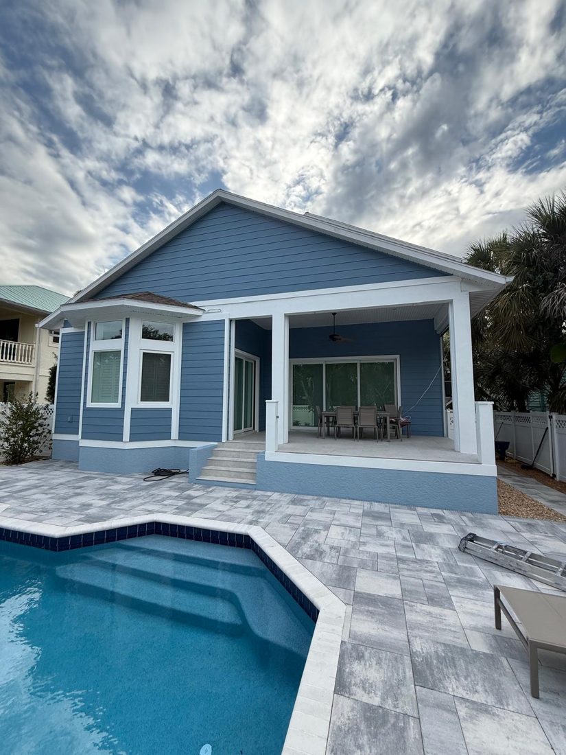 Exterior repaint, coastal two-story, the same surface after the work was finished