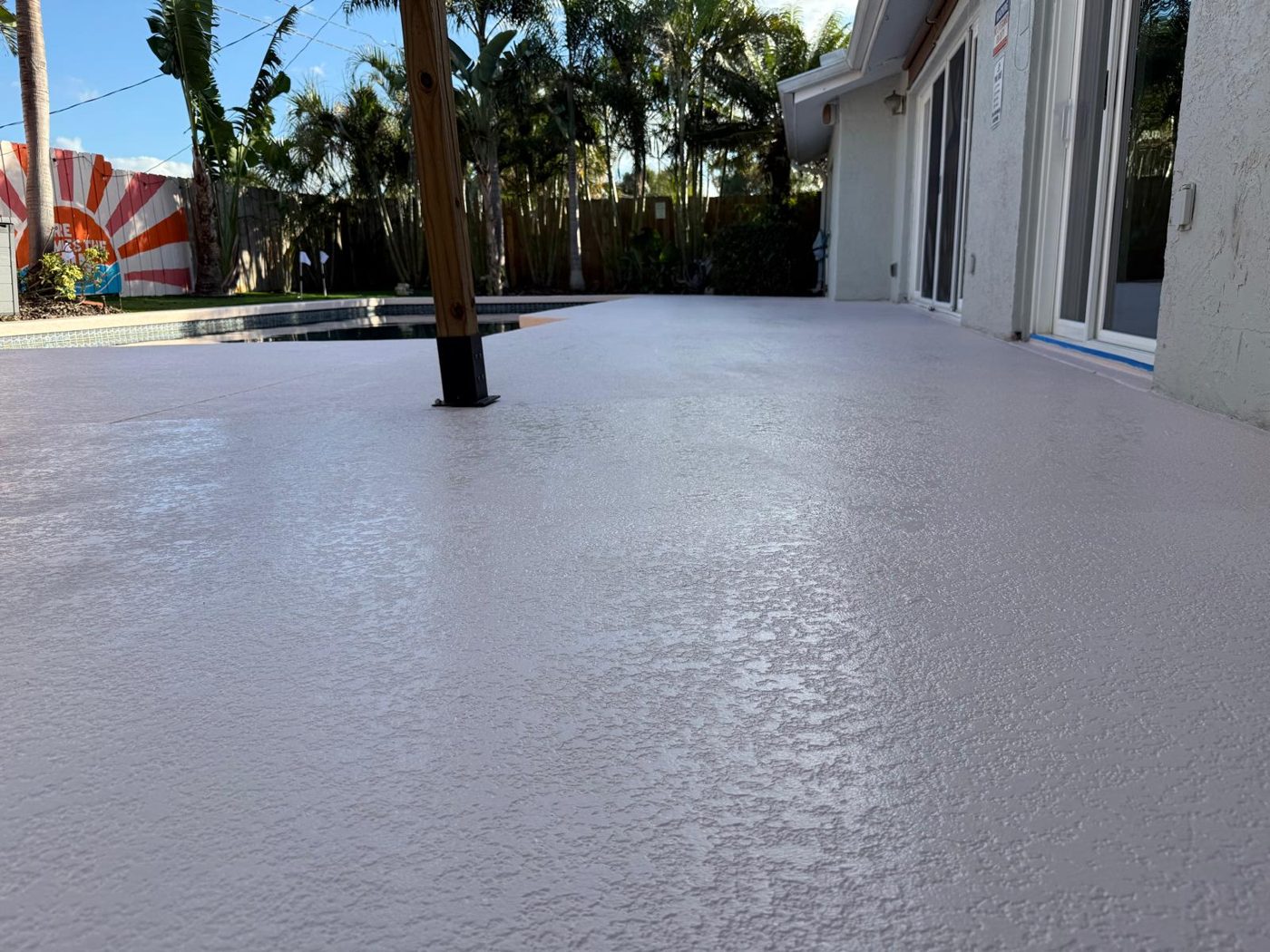 Pool deck resurfaced with a textured non-slip coating by WCS Prime Services in Sarasota, FL