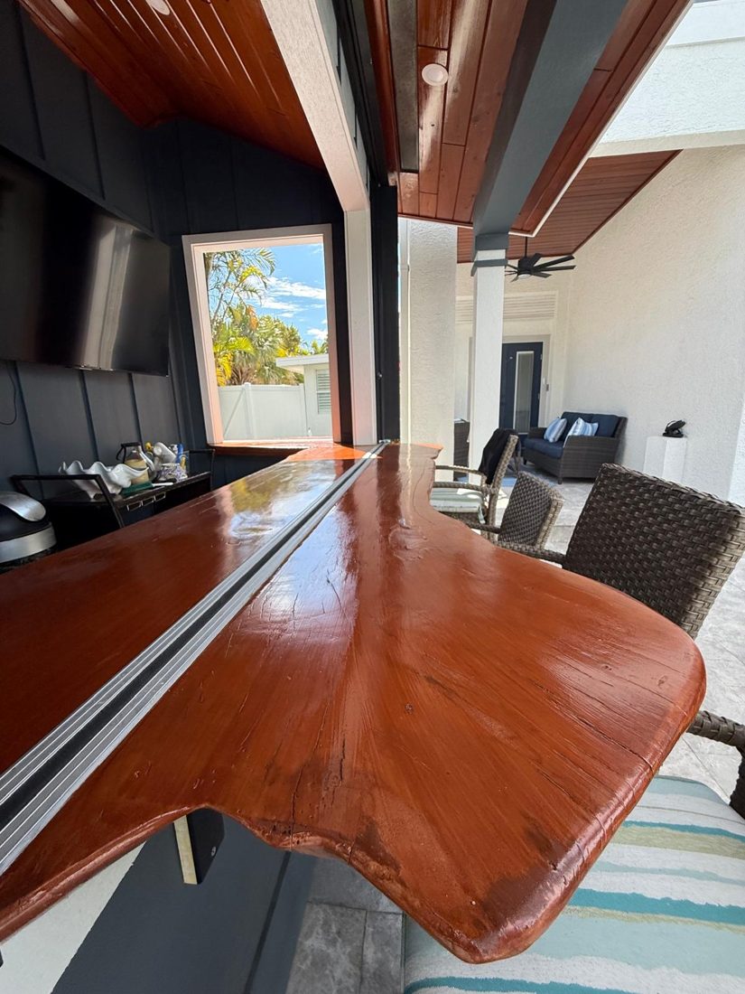 Live-edge slab sanded, stained and sealed into an outdoor bar top by WCS Prime Services in Sarasota, FL