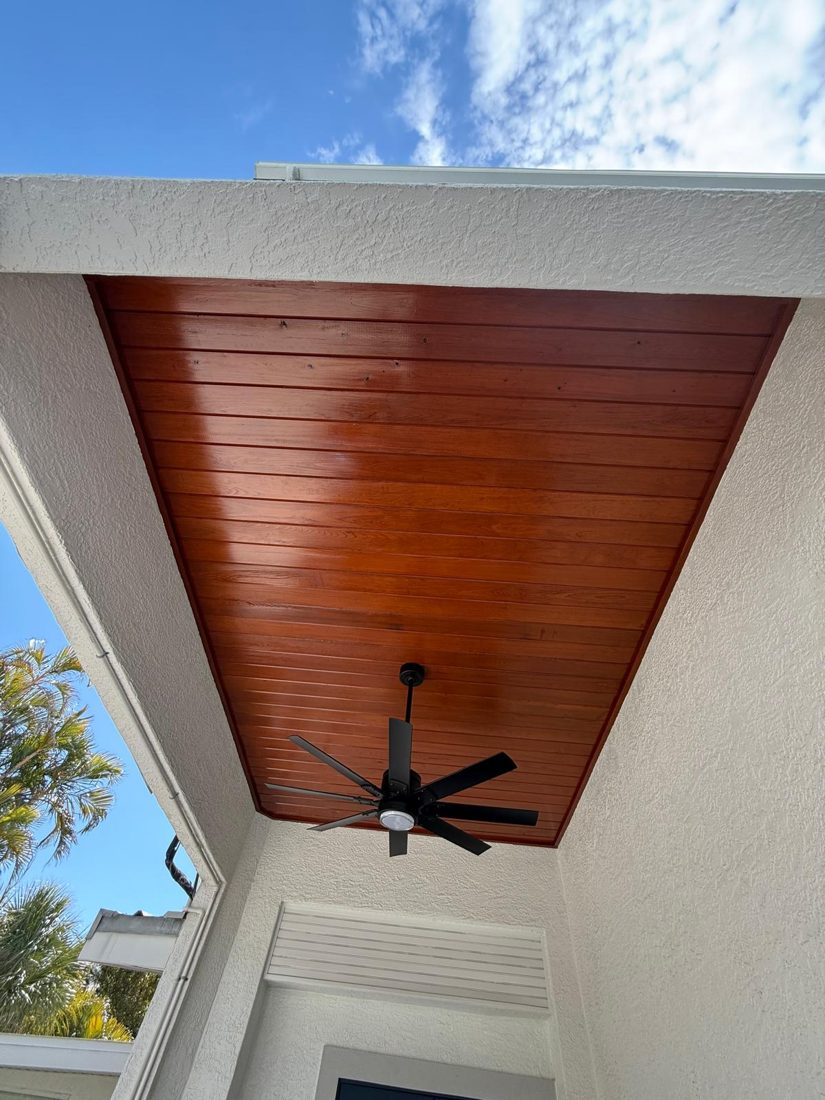 Cedar soffit sanded back and re-stained to a deep even tone under a Florida roofline
